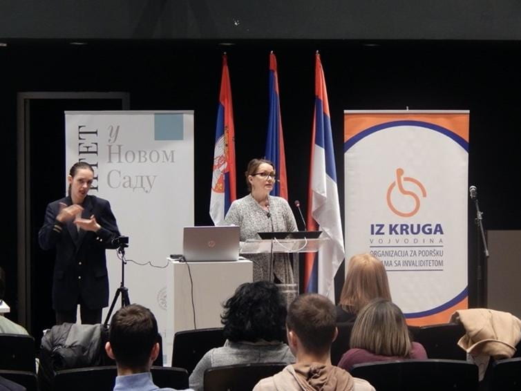 Andjela Kaur speaking at a podium at The International Conference "Why Do We Need Disability Studies?" at the University of Novi Sad.